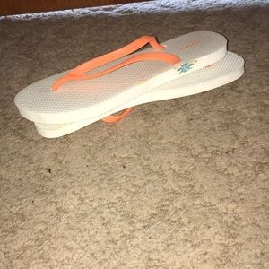 White and orange flip flops